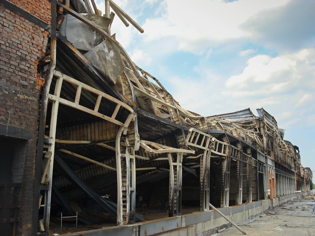 A warehouse with a burnt metal frame from a fire